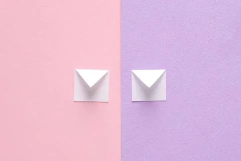 Two white envelopes on pink and purple paper background Stock Photos