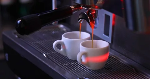 Two white espresso cups in a coffee machine Stockbeeldmateriaal 122372084