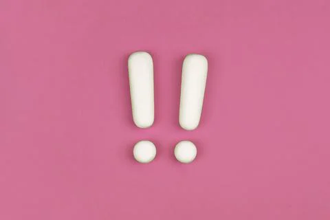 Two white exclamation marks on pink background. Flat lay, warning sign, keep Stock Photos
