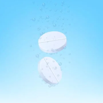 Two white fizzy tablets dissolving in blue liquid realistic vector illustration. Stock Illustration