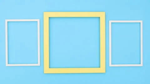 Two white frames moving around yellow big frame on blue theme. Stop motion Stock Footage 138183938