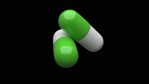 Two white-green pills rotating. Video stock 132946986