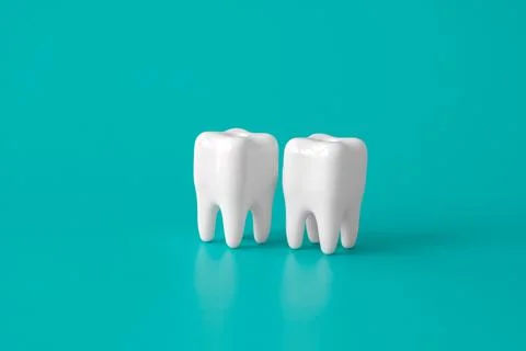 Two white human tooth models on a blue medical background. Dental health mini Stock Photos