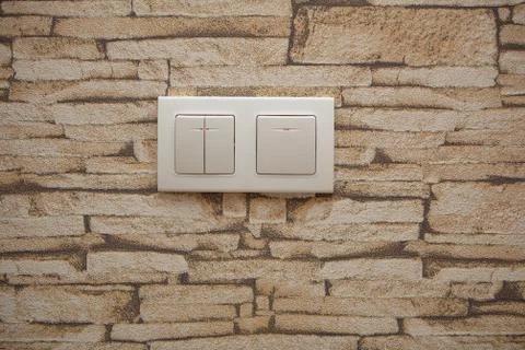 Two white lighting switchs on concrete wall, on and off Foto stock