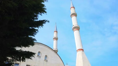 Two white minarets on background of blue sky. Dome of roof of mosque. Stock Footage 131093181
