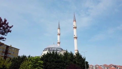 Two white minarets on background of blue sky. Dome of roof of mosque. Stock Footage 131093663