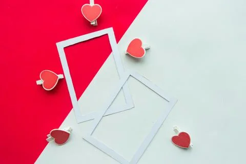 Two white mockup photo frames decorative with hearts on geometric white and r Stock Photos