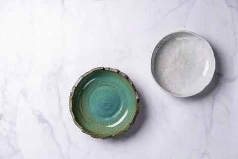 Two white new plates of different size on a white background Foto stock