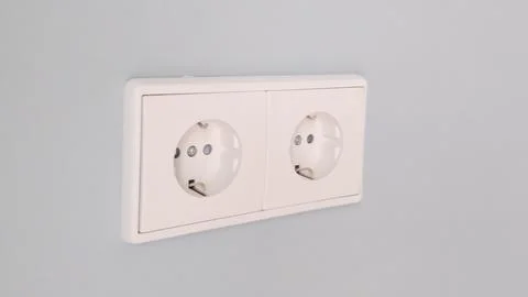 Two white outlets on a wall Stock Photos