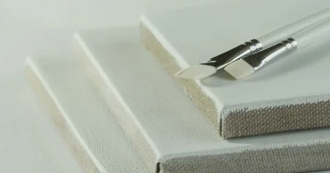 Two white paintbrushes and three canvas. Stock Footage 50182218
