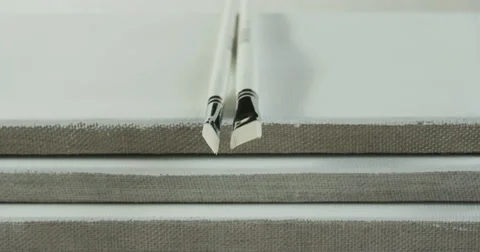 Two white paintbrushes and three canvas. Stock Footage 50182898