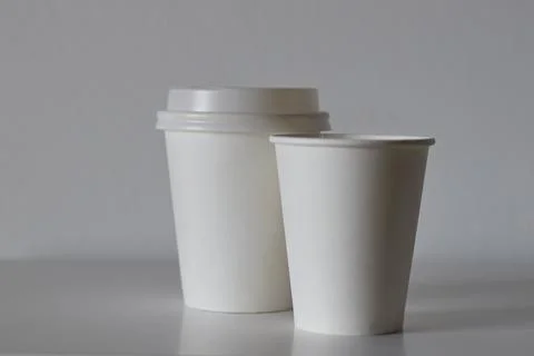 Two white paper cups on table, mockup for design Stock Photos