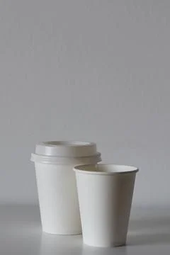 Two white paper cups on table, mockup for design Stock Photos