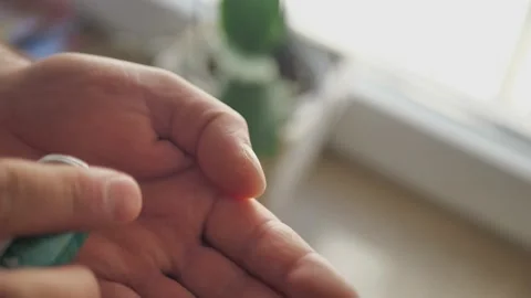 Two white pills fall on palm from bottle. Close-up Stock Footage 172370864