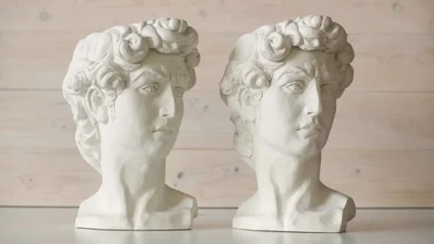 Two white plaster heads of David stand side by side Stock Footage 156631788