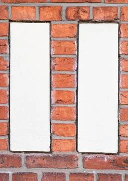 Two White Plaster Panels Framed by Red Brick  Geometric Faade Detail 写真素材