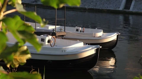 Two White plastic boats on a river at sunny day. Stock Footage 124245206
