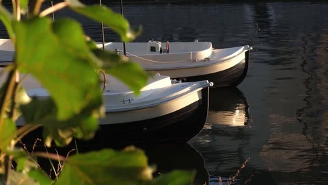 Two White plastic boats on a river at sunny day. Stock Footage 124245257