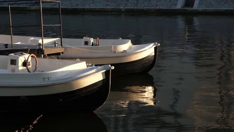 Two White plastic boats on a river at sunny day. Stock Footage 124245258
