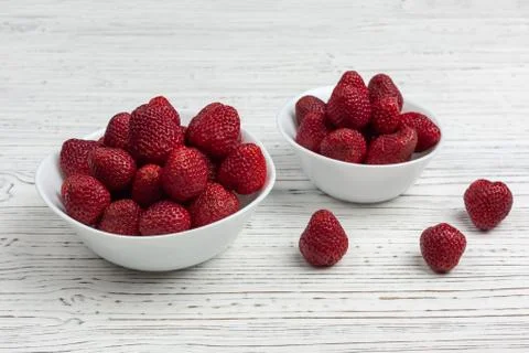 Two white plates with strawberries Stock Photos