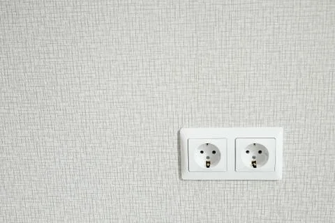 Two white Power sockets with frame on light wallpaper as a background Stock Photos