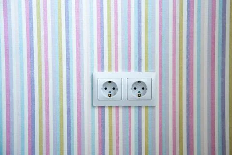 Two white Power sockets with frame on color wallpaper as a background Stock Photos