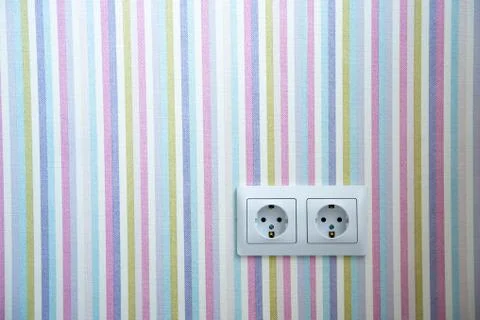 Two white Power sockets with frame on color wallpaper as a background with co Stock Photos