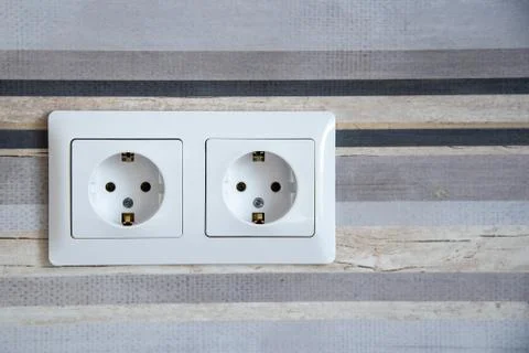 Two white Power sockets with frame on ceramic tile as a background Stock Photos