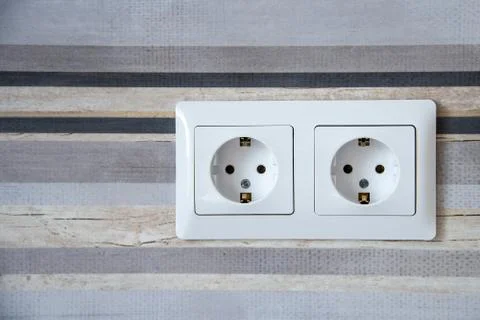 Two white Power sockets with frame on ceramic tile as a background Stock Photos