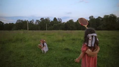 Two white red-haired sisters play badminton Stock Footage 218299502