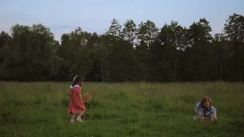 Two white red-haired sisters play badminton Video stock 218300186