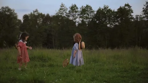Two white red-haired sisters play badminton Video stock 218300641