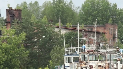 Two white seagulls fly over abandoned flooded boats Stock Footage 78123235