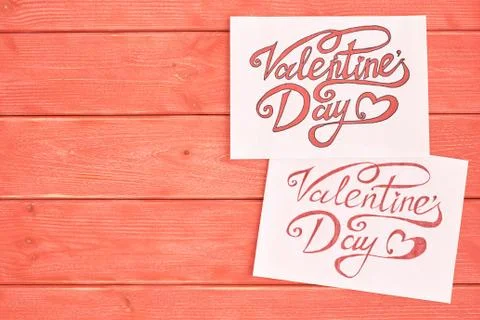 Two white sheet of paper with a message, letter to valentines day, wooden pine Fotos Stock