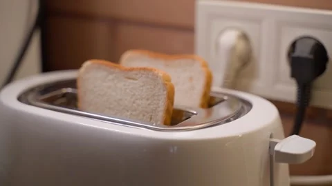 Two white slices of bread being put in a toaster, close-up Stock Footage 322170224