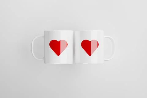 Two white tea cups with red hearts on it, lying on white background. Ultra Stock Illustration
