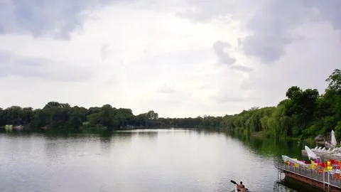 Two white unrecognizable men in kayak on a lake in Bela Crkva in cloudy day Stock Footage 269165106
