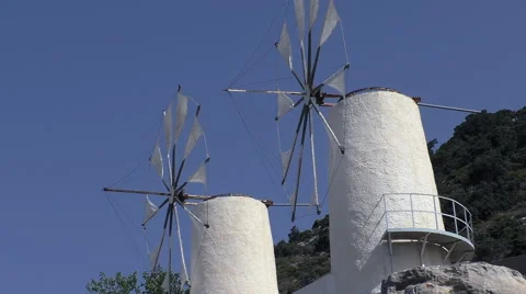 Two white windmills turning slowly Stockbeeldmateriaal 52451059