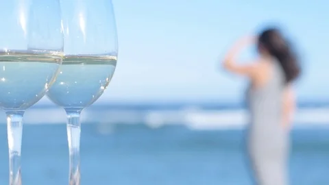 Two white wine wineglasses over sea background. Stock Footage 83211012