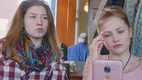 Two white young blondes have funny chat at table in cafe Stock Footage 89281167