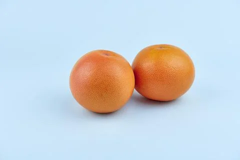 Two whole grapefruits on a white background Stock Photos