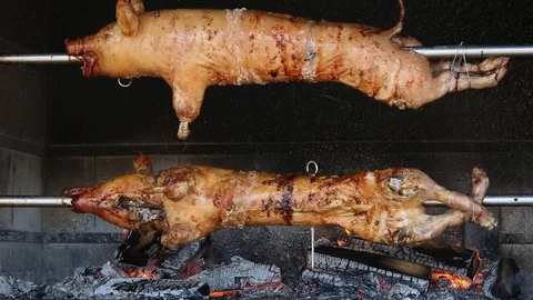 Two Whole Pigs Rotating on the Spits 動画素材 110775866
