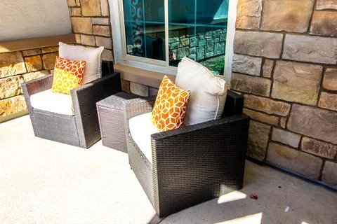 Two Wicker Arm Chairs On Front Patio Stock Photos