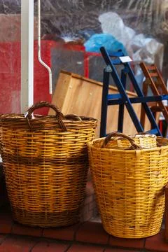 Two wicker baskets are currently sitting on a sturdy brick floor Stock Photos