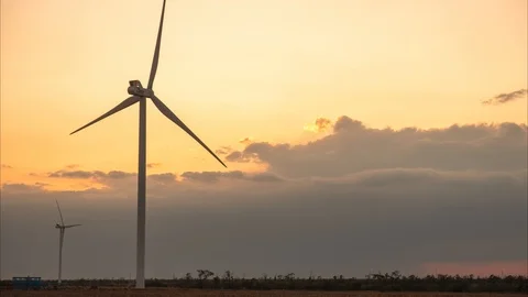 Two wind generators against the backdrop of the sunset and huge clouds. time Video stock 118076119