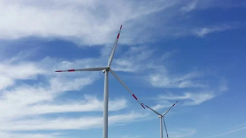 Two wind turbines in a farm, generating renewable electrical energy Stock Footage 160767145