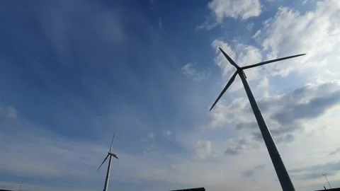 Two wind turbines in a farm, generating renewable electrical energy Stock Footage 223728067