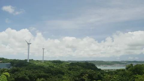 Two wind turbines on the hill with an ocean view Stock Footage 157136166
