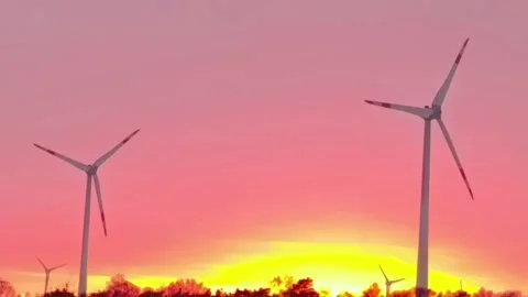 Two Wind Turbines Rotating at Pink Sunset Sky Stock Footage 326144706