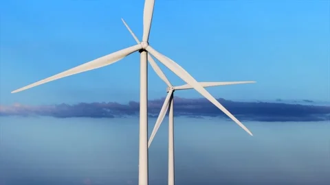 Two Wind Turbines Spinning Under Blue Sky Stock Footage 344793172